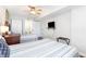 Comfortable bedroom with twin beds, ceiling fan, and a flatscreen TV for relaxing stays at 1707 Perrin Dr. # 1003, North Myrtle Beach, SC 29582
