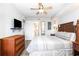 Bedroom with a television, woven headboard, and ensuite bathroom at 1707 Perrin Dr. # 1003, North Myrtle Beach, SC 29582