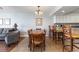 Open dining area with wood table and seating for six and kitchen bar with stool seating at 1707 Perrin Dr. # 1003, North Myrtle Beach, SC 29582