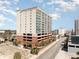 A full exterior view of the building showcasing its modern design, parking garage, and multiple balconies on each level at 1707 Perrin Dr. # 1003, North Myrtle Beach, SC 29582