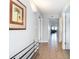 Bright hallway with neutral walls, tile flooring, and decorative palm tree art, leading to living spaces at 1707 Perrin Dr. # 1003, North Myrtle Beach, SC 29582
