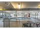 Indoor pool with a safety fence, tables, chairs, and sliding glass doors, providing a recreational space within the building at 1707 Perrin Dr. # 1003, North Myrtle Beach, SC 29582