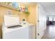 This laundry room has a washing machine and dryer and shelving for storage at 1707 Perrin Dr. # 1003, North Myrtle Beach, SC 29582