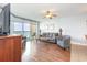 Open concept living room with comfortable seating and sliding glass doors to balcony with ocean view at 1707 Perrin Dr. # 1003, North Myrtle Beach, SC 29582