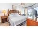 Comfortable bedroom with a balcony that has ocean views from the expansive windows at 1707 Perrin Dr. # 1003, North Myrtle Beach, SC 29582