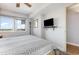 Comfortable bedroom featuring a ceiling fan, TV, and large window providing lots of natural light at 1707 Perrin Dr. # 802, North Myrtle Beach, SC 29582