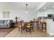 Cozy dining area with bar seating and a wooden dining table with views into the living room at 1707 Perrin Dr. # 802, North Myrtle Beach, SC 29582