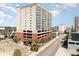 Multi-story condo building featuring balconies overlooking the streets with palm tree lined entrance at 1707 Perrin Dr. # 802, North Myrtle Beach, SC 29582