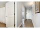 Hallway featuring tile flooring leading to the condo's entrance with white painted doors at 1707 Perrin Dr. # 802, North Myrtle Beach, SC 29582
