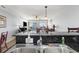 Kitchen featuring stainless steel dual sink and bar height countertop offering a view into the living room at 1707 Perrin Dr. # 802, North Myrtle Beach, SC 29582