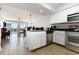 Bright, open kitchen with stainless appliances, white cabinets, and a view into the adjacent living area at 1707 Perrin Dr. # 802, North Myrtle Beach, SC 29582