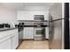 Well-equipped kitchen featuring stainless steel appliances and white cabinets, offering modern convenience at 1707 Perrin Dr. # 802, North Myrtle Beach, SC 29582