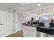 Open-concept kitchen with granite countertops and stainless dishwasher, offering a seamless transition to the living space at 1707 Perrin Dr. # 802, North Myrtle Beach, SC 29582