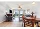 Comfortable living room with hardwood and tile flooring, and dining area near a large window at 1707 Perrin Dr. # 802, North Myrtle Beach, SC 29582