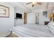 Cozy bedroom with a ceiling fan, TV, and access to an ensuite bathroom at 1707 Perrin Dr. # 802, North Myrtle Beach, SC 29582
