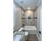 Bathroom featuring vanity, tub with tile surround, and wood look flooring at 1795 Hemingway St., Conway, SC 29527