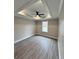 Bedroom with a tray ceiling, ceiling fan, and a window to let in natural light at 1795 Hemingway St., Conway, SC 29527
