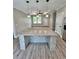 Spacious kitchen island with stunning granite top, pendant lighting and wood-look floors at 1795 Hemingway St., Conway, SC 29527