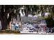 Street view showcasing the neighborhood's quaint charm with tree canopies and a pedestrian crossing the road at 1795 Hemingway St., Conway, SC 29527