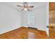 This cozy bedroom features hardwood floors, white walls, and a ceiling fan at 1907 Rose St., Conway, SC 29527
