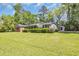 This ranch-style home offers a well-manicured lawn, brick facade, and mature trees at 1907 Rose St., Conway, SC 29527