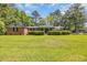 Charming single-story brick home with a well-manicured lawn and lush greenery in a serene neighborhood at 1907 Rose St., Conway, SC 29527