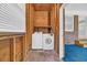 This laundry room features a washer and dryer, with a window nearby for light at 1907 Rose St., Conway, SC 29527