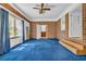This large living room offers brick walls, blue carpet and an adjacent room at 1907 Rose St., Conway, SC 29527