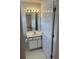 Bathroom features vanity, mirror, lighting, toilet, and flooring, with a door leading to another room at 193 Charter Dr. # E3, Longs, SC 29568