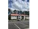 Exterior view of an apartment building with a red roof and balconies over parking spaces at 193 Charter Dr. # E3, Longs, SC 29568