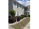 Apartment exterior with red roof, screen in porch, and well-maintained landscaping at 193 Charter Dr. # E3, Longs, SC 29568