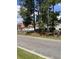 Community street view with mature trees and red roofed apartments at 193 Charter Dr. # E3, Longs, SC 29568