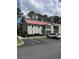 Exterior view of an apartment building with a red roof and screened in balconies at 193 Charter Dr. # E3, Longs, SC 29568