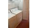 Features white washing machine and dryer set against a neutral wall with an adjacent white door at 193 Charter Dr. # E3, Longs, SC 29568