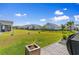 Expansive backyard with lush green grass and views of neighboring houses in a community setting at 194 Zostera Dr., Little River, SC 29566