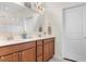 Bathroom features a double sink vanity with wooden cabinets, modern fixtures, and a large mirror at 194 Zostera Dr., Little River, SC 29566