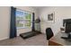 Bedroom with treadmill, desk, a window, and a view of the neighborhood at 194 Zostera Dr., Little River, SC 29566