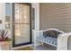 Charming front entrance with a bench, stylish door, and welcoming potted plants at 194 Zostera Dr., Little River, SC 29566