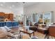 Open-concept living room featuring wood floors, leather furniture, and access to the dining room and kitchen at 194 Zostera Dr., Little River, SC 29566
