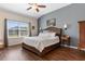 Main bedroom featuring a vaulted ceiling, a large window, and classic furnishings at 194 Zostera Dr., Little River, SC 29566