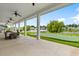 A covered outdoor space that includes ceiling fans, views of the putting green and surrounding lake at 194 Zostera Dr., Little River, SC 29566