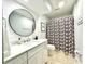 Bathroom featuring modern vanity, round mirror, white shiplap, and shower with leafy curtain at 201 N Hillside Dr. # 311-A, North Myrtle Beach, SC 29582