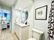 Bathroom featuring modern vanity, round mirror, white shiplap and leafy shower curtain at 201 N Hillside Dr. # 311-A, North Myrtle Beach, SC 29582