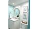 This bathroom has a modern vanity, shiplap accent wall, and stylish round mirror at 201 N Hillside Dr. # 311-A, North Myrtle Beach, SC 29582