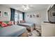 Bright bedroom with two twin beds, colorful floral pillows, coastal artwork and curtains at 201 N Hillside Dr. # 311-A, North Myrtle Beach, SC 29582