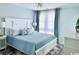Relaxing bedroom with a king bed, white furniture, and large windows with blue curtains at 201 N Hillside Dr. # 311-A, North Myrtle Beach, SC 29582