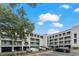 Condo building exterior with ample parking on a partly cloudy day at 201 N Hillside Dr. # 311-A, North Myrtle Beach, SC 29582