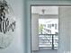 A welcome sign hangs on the wall in a hallway leading to a balcony area at 201 N Hillside Dr. # 311-A, North Myrtle Beach, SC 29582