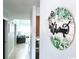 A welcome sign hangs on the wall in a hallway, opening to the living room at 201 N Hillside Dr. # 311-A, North Myrtle Beach, SC 29582
