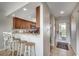 Bright kitchen featuring granite counters, wooden cabinets, bar seating and stainless steel appliances at 201 N Hillside Dr. # 311-A, North Myrtle Beach, SC 29582